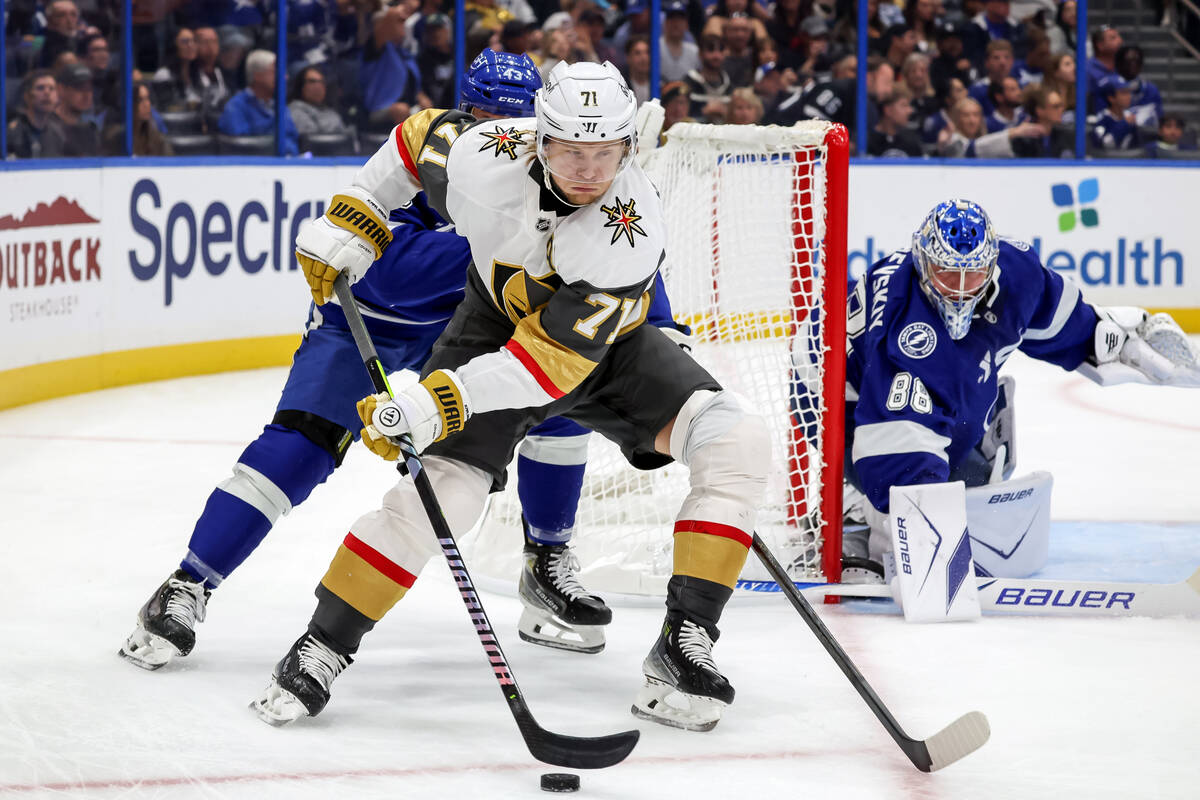 Vegas Golden Knights' William Karlsson (71) takes the puck behind Tampa Bay Lightning goal ...