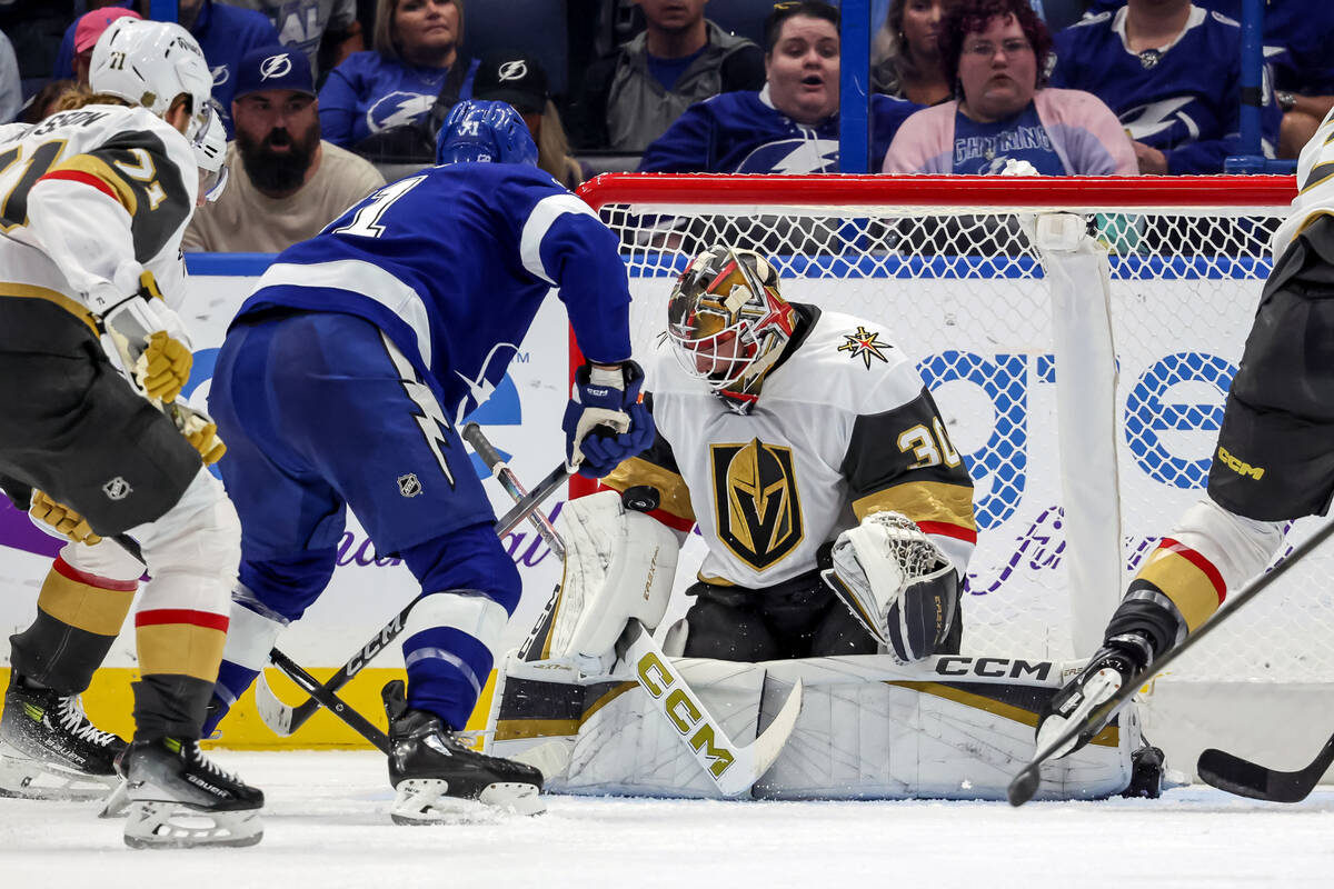In his NHL debut, Vegas Golden Knights goaltender Carl Lindbom (30) makes a save against Tampa ...