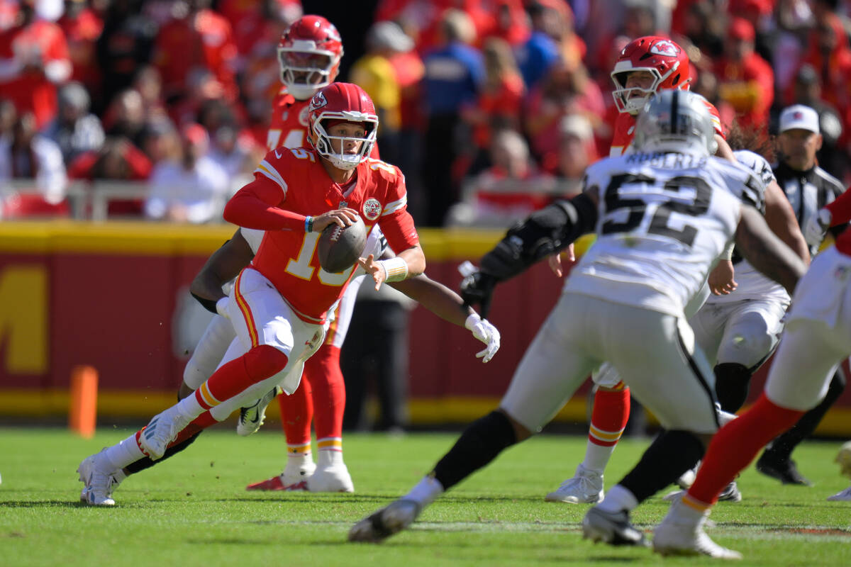 Kansas City Chiefs quarterback Patrick Mahomes scrambles during the first half of an NFL footba ...