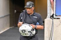Former Oakland Raiders safety George Atkinson signs his autograph before the NFL football exhib ...