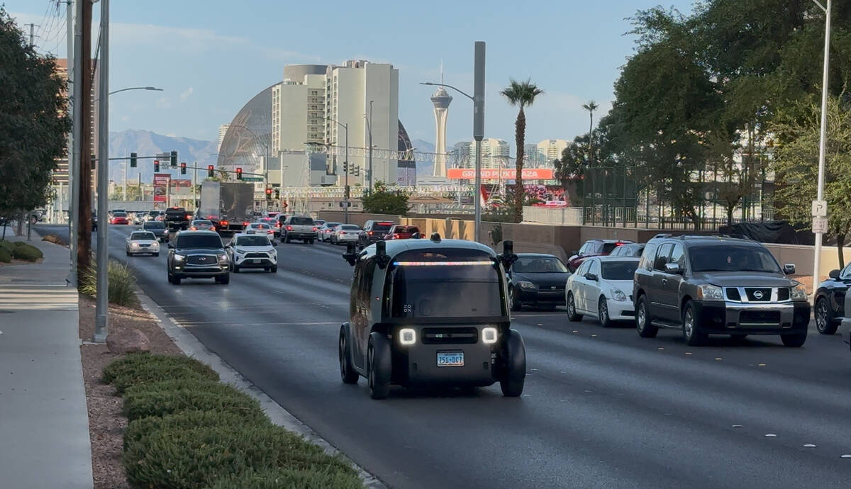 A Zoox robotaxi travels on Koval Lane with Sphere in the background on Friday, Sept. 5, 2025, i ...