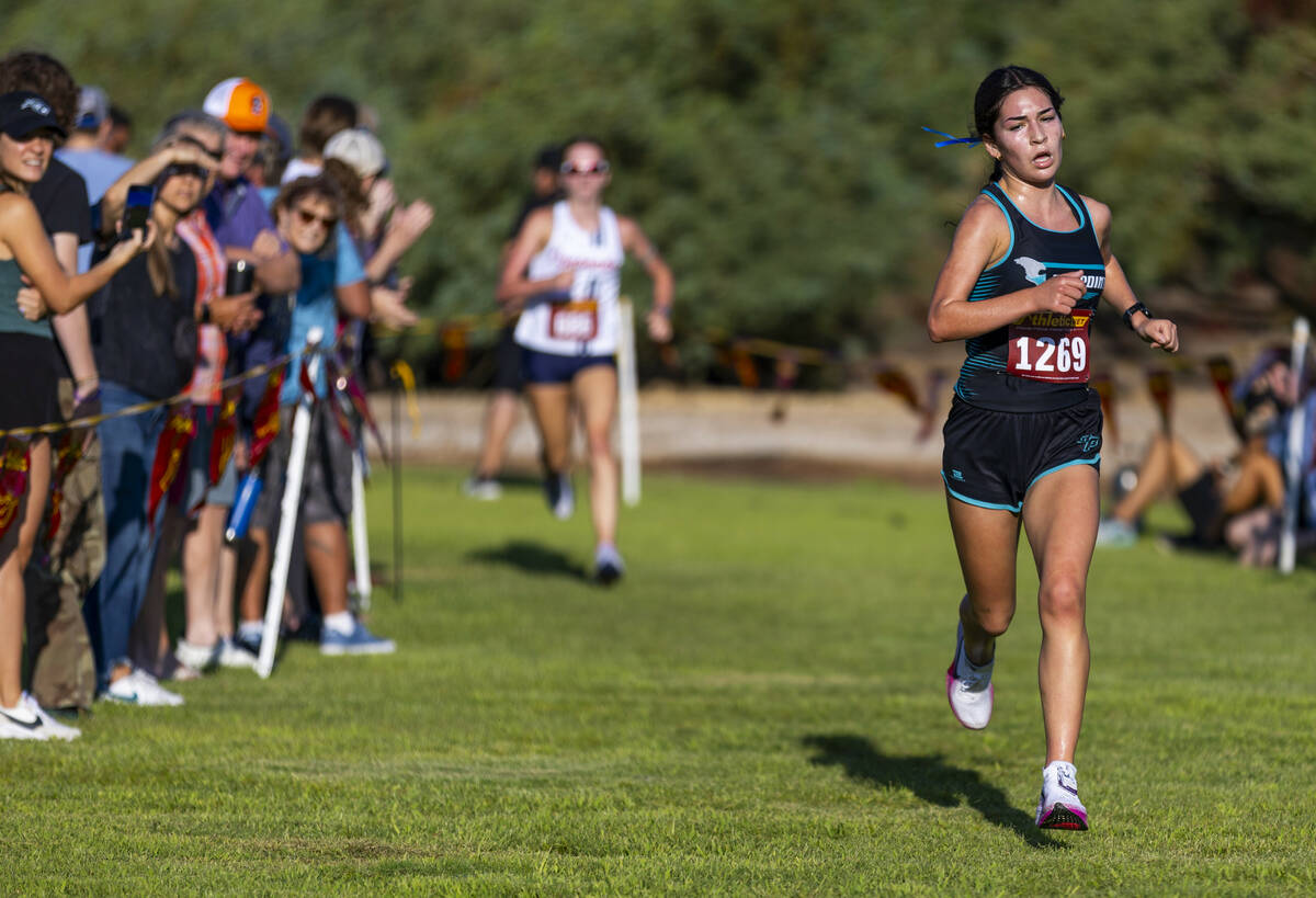 Somerset Academy Sky Pointe High School runner Aislin McMahon (1269) nears the finish line ...