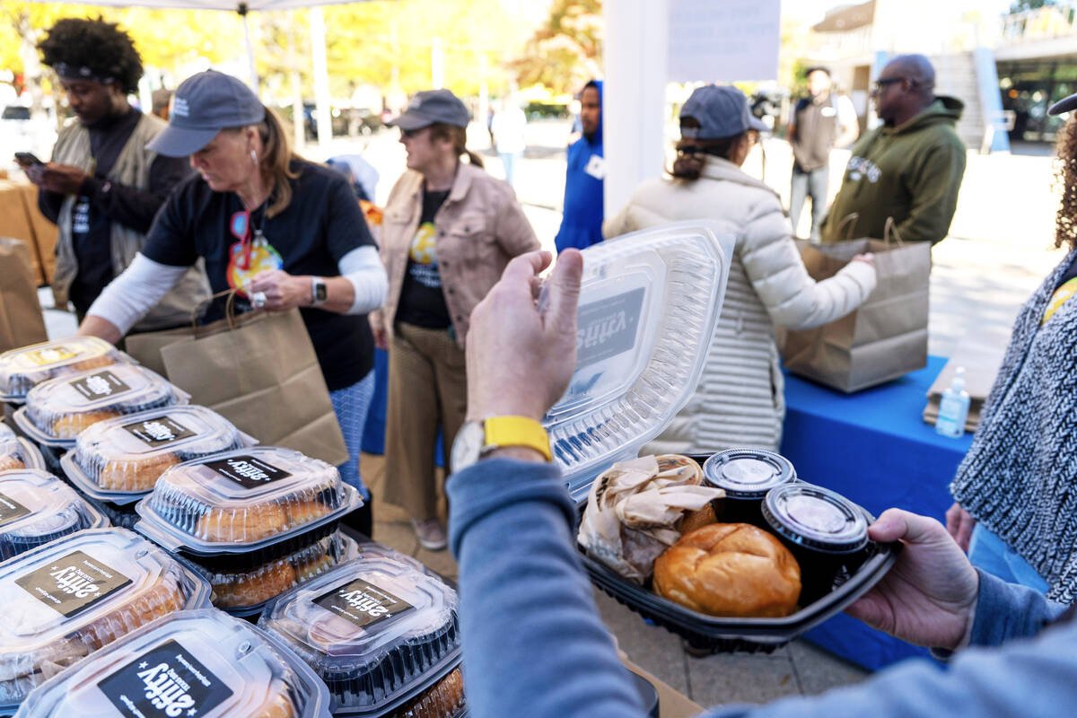 A meal is checked as workers with chef Jose Andres' World Central Kitchen distribute more ...