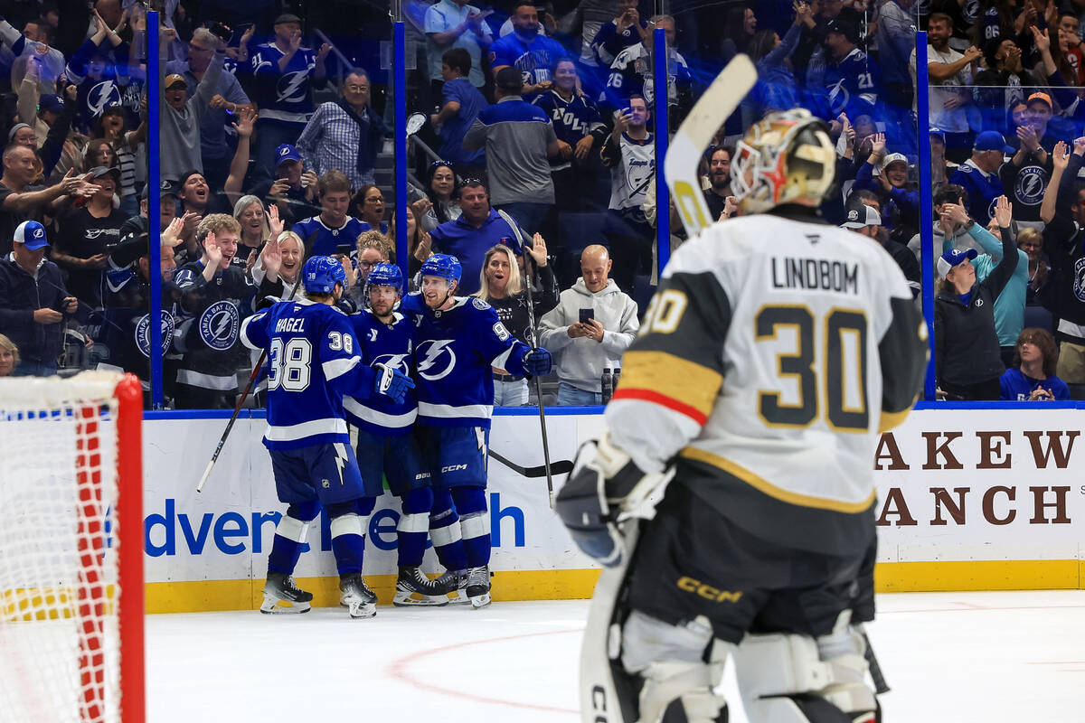 Tampa Bay Lightning's Nikita Kucherov, center back left, celebrates after his winning goal ...