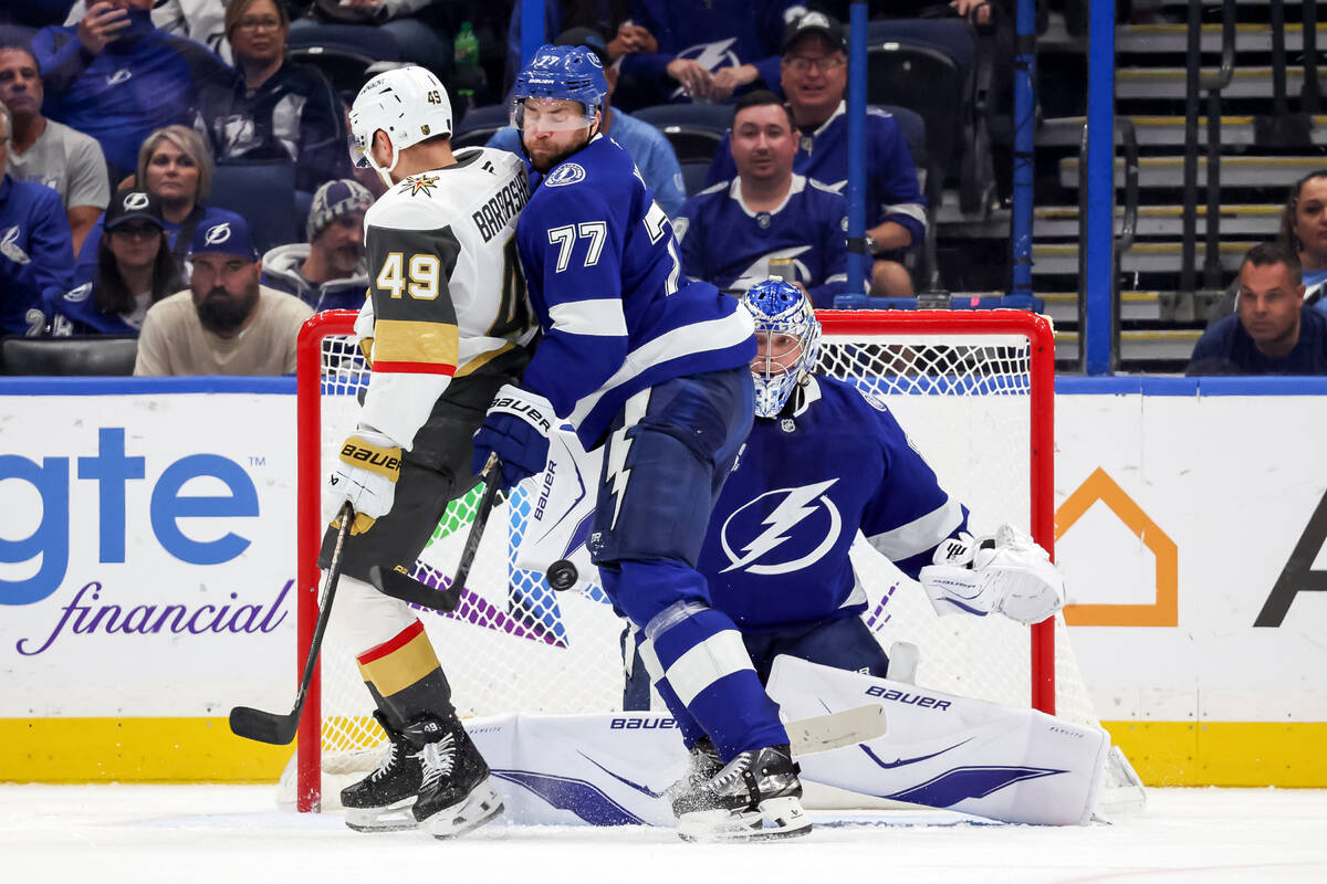 Tampa Bay Lightning goaltender Andrei Vasilevskiy, right, makes a save behind Lightning defense ...