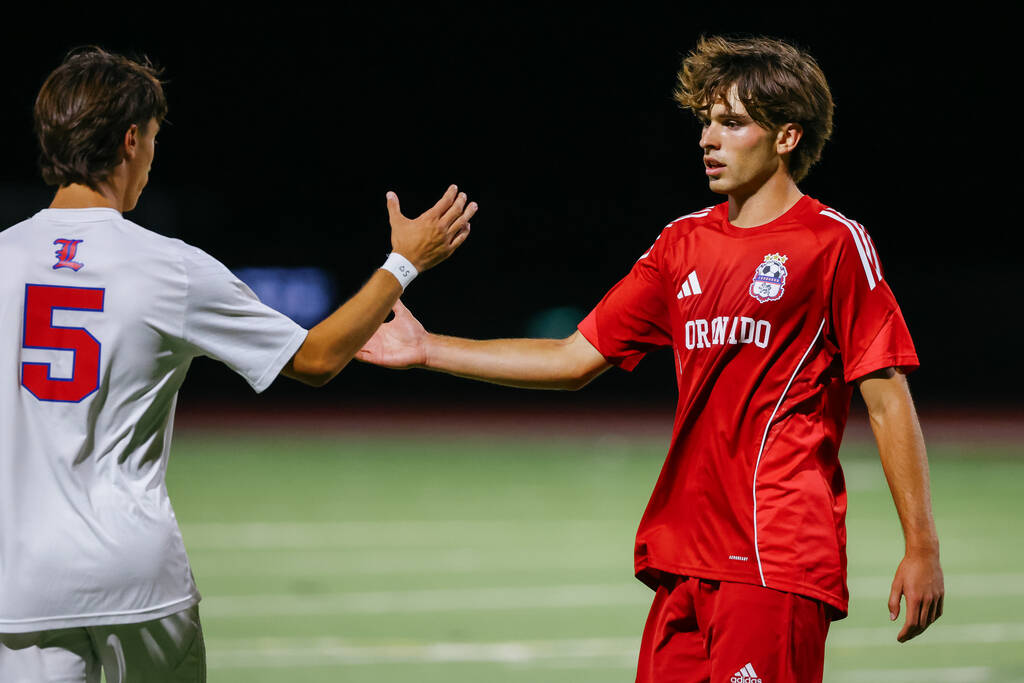 Coronado striker Gavin Flickinger (11) shakes hands with Liberty defender Diego Bermudez (5) af ...