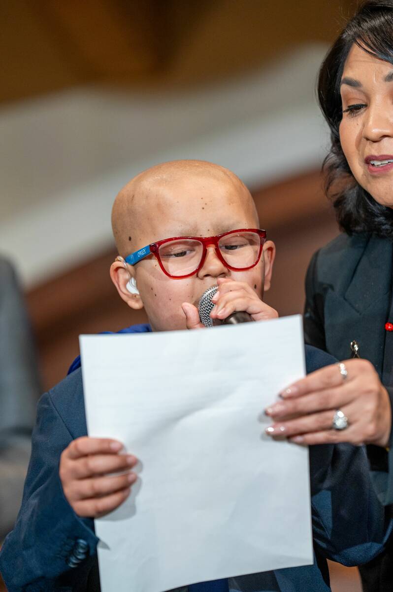 Benji Sanchez, 11, or "Super Benji," reads a statement about his cancer journey and the care he ...