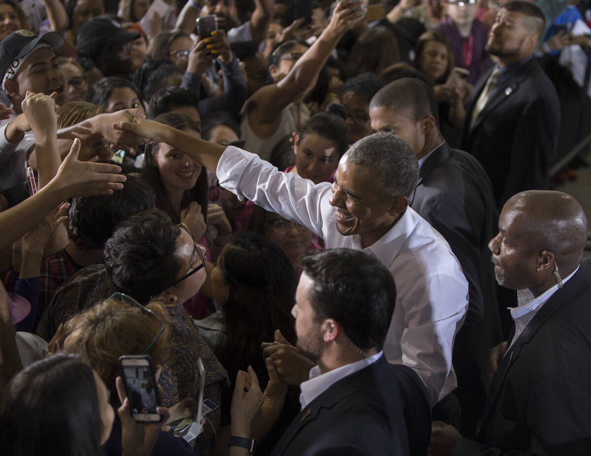 Former President Barack Obama, right, shakes hands with the crowd in Las Vegas. Las Vegas Revie ...