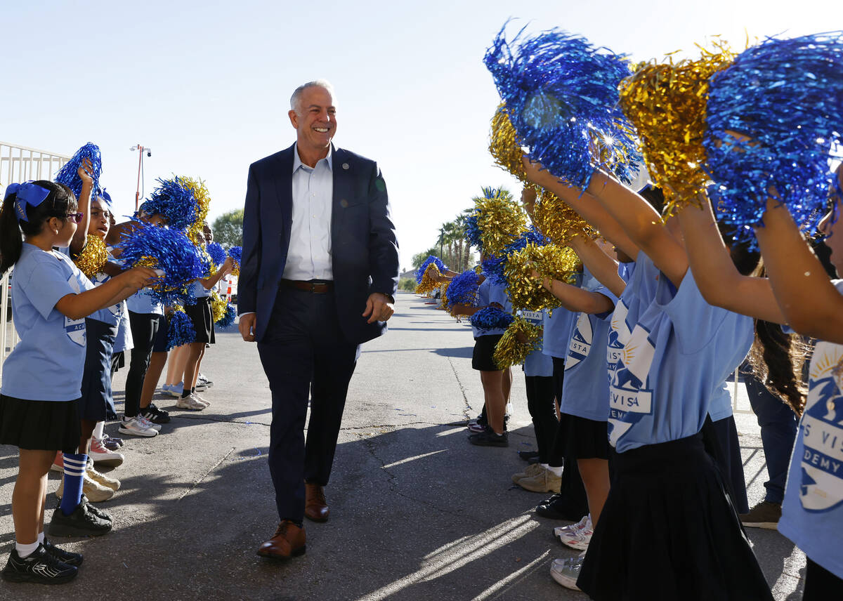 Gov. Joe Lombardo is greeted by Vegas Vista Academy cheerleaders as he arrives to attend a pres ...