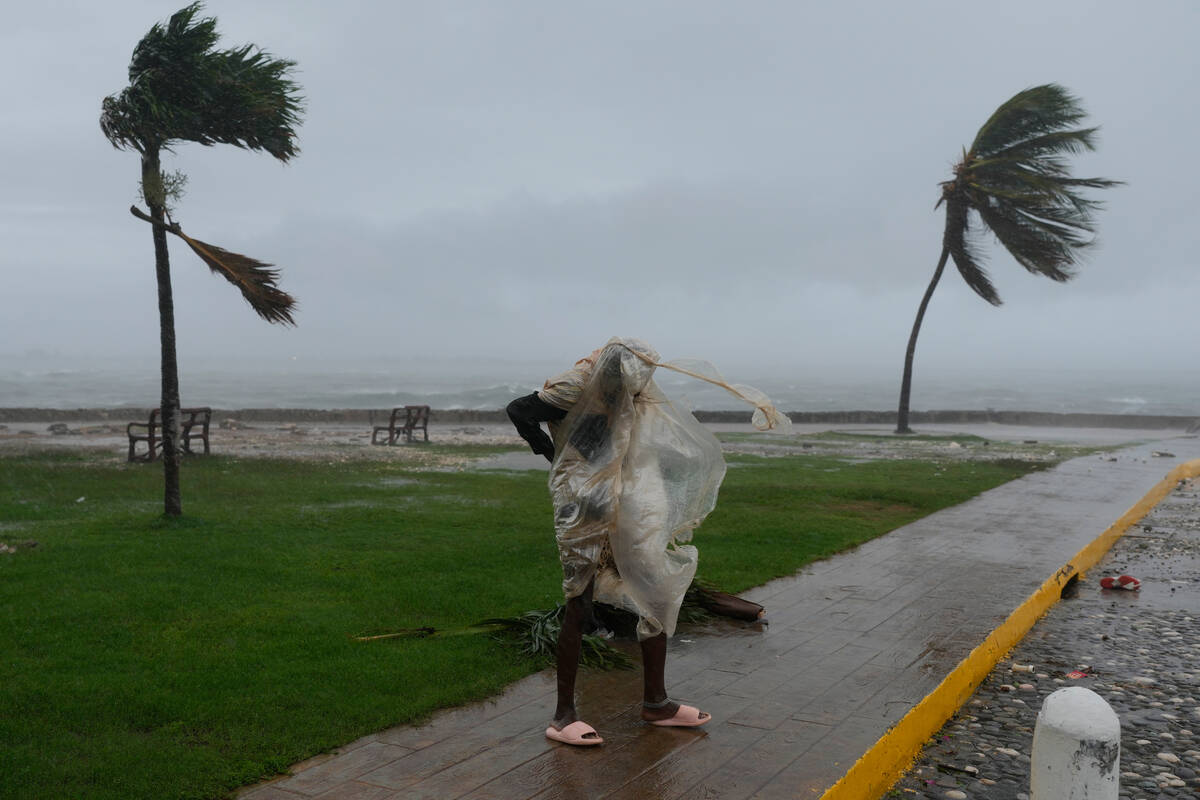 A man walks in Kingston, Jamaica, as Hurricane Melissa approaches, Tuesday, Oct. 28, 2025. (AP ...