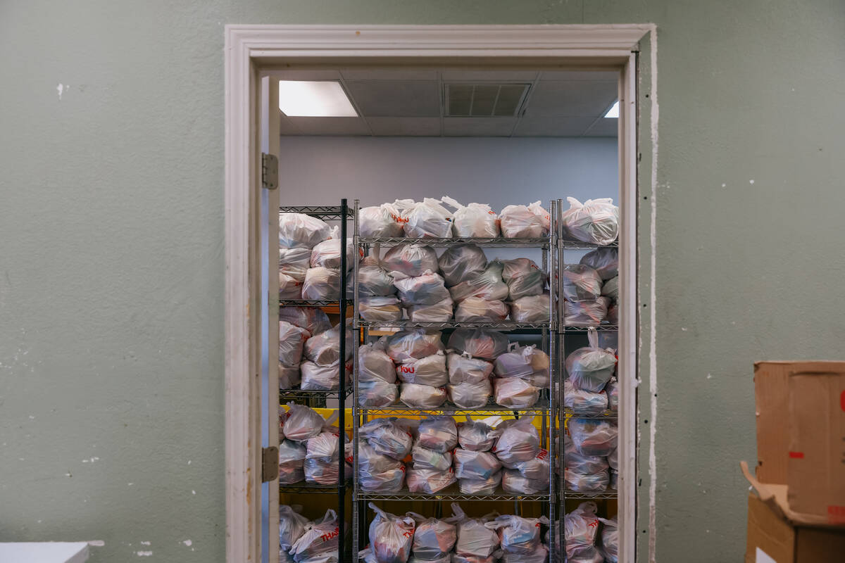 Bags of food supplies sit on racks at City Impact Urban Food Bank on Tuesday, Oct. 28, 2025 in ...