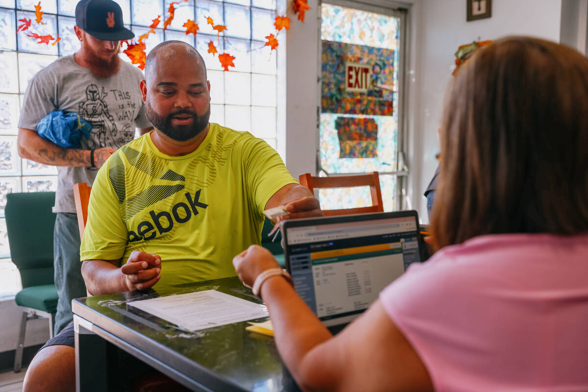 Randy Alberto Gonzalez checks in to receive food at City Impact Urban Food Bank on Tuesday, Oct ...