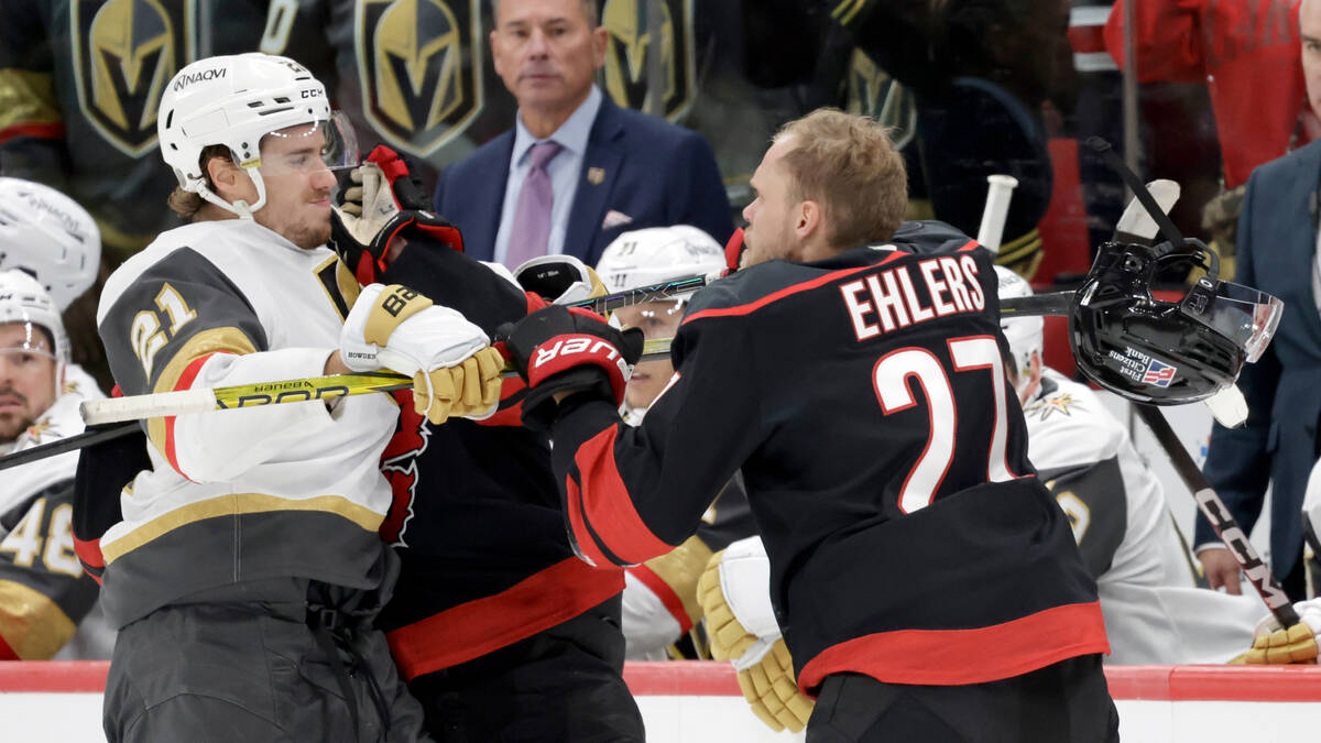 Vegas Golden Knights center Brett Howden (21) mixes it up with Carolina Hurricanes left wing Ni ...