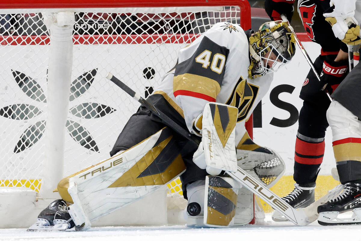 Vegas Golden Knights goaltender Akira Schmid (40) stops a shot against the Carolina Hurricanes ...