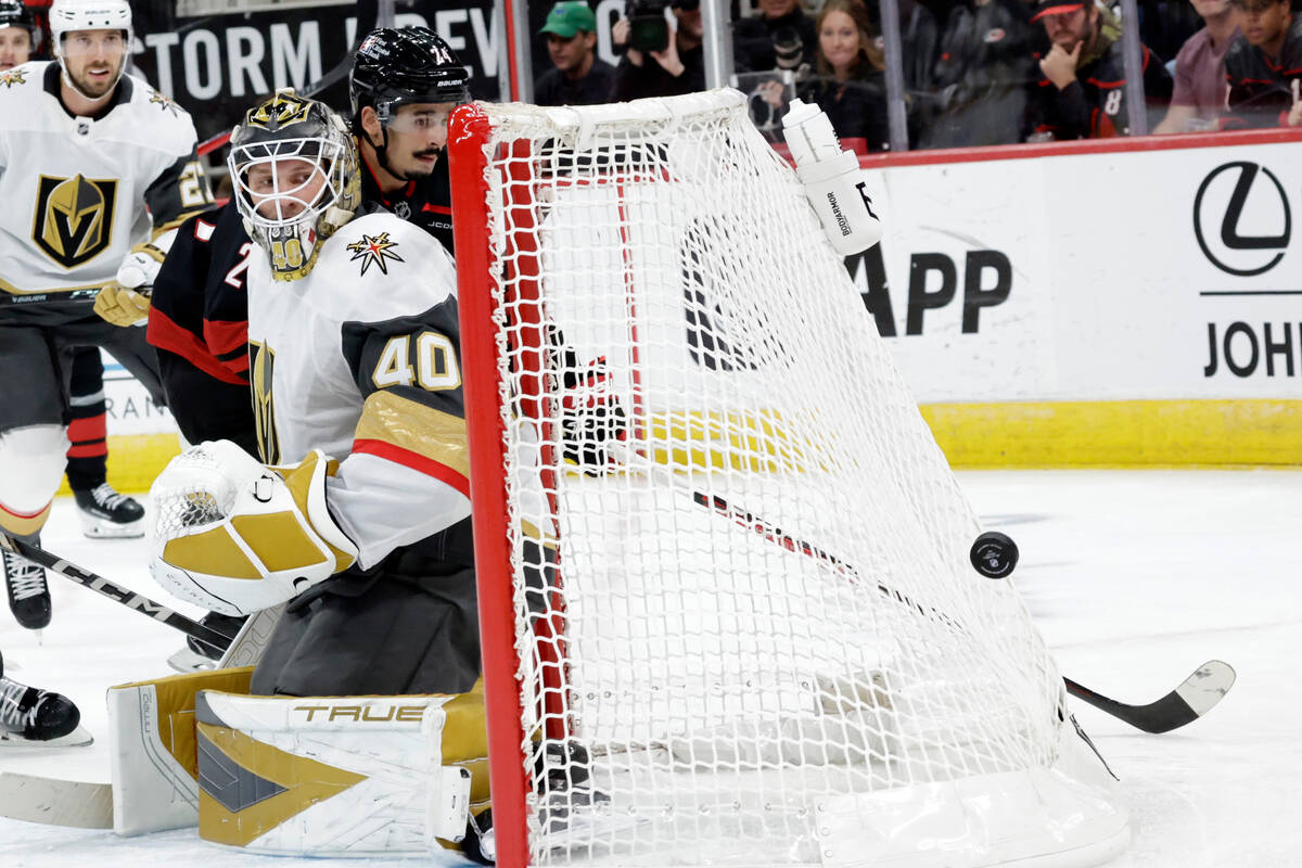 Vegas Golden Knights goaltender Akira Schmid (40) and Carolina Hurricanes center Seth Jarvis, r ...