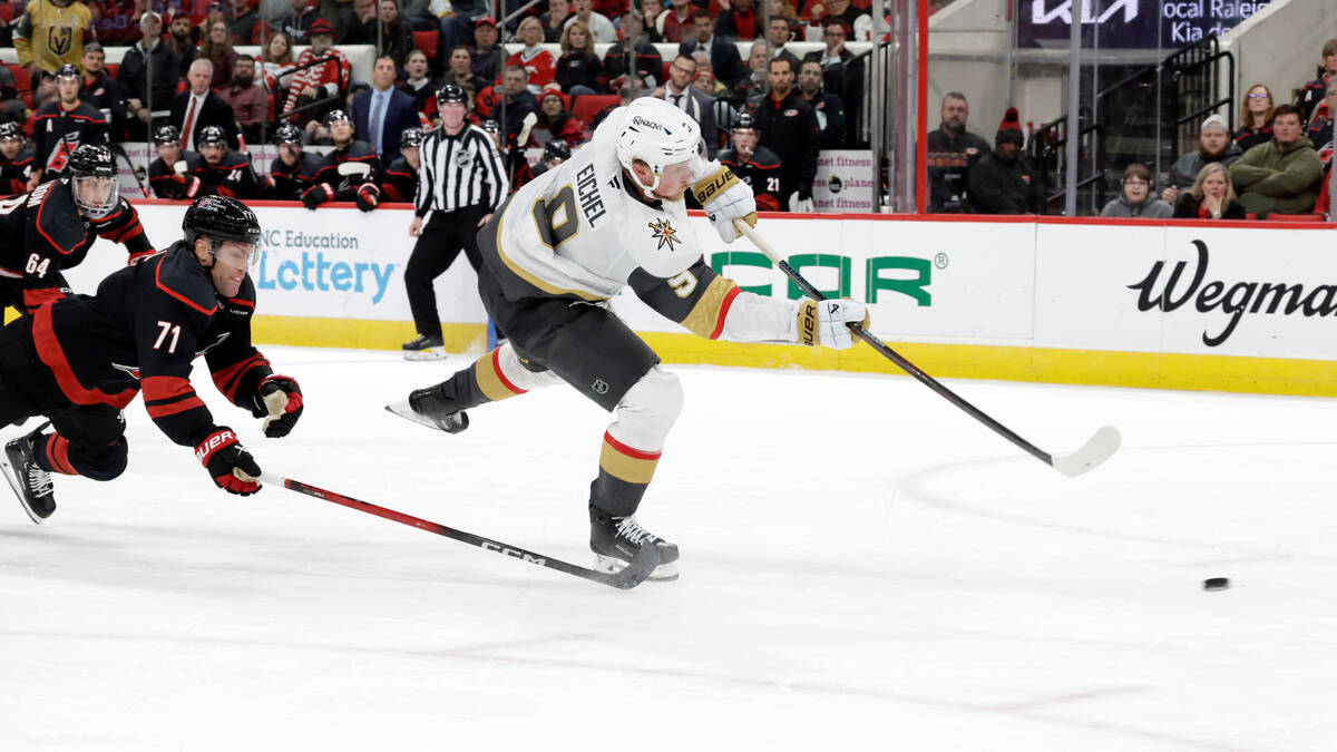 Vegas Golden Knights center Jack Eichel (9) fires the puck for a goal as he is defended by Caro ...