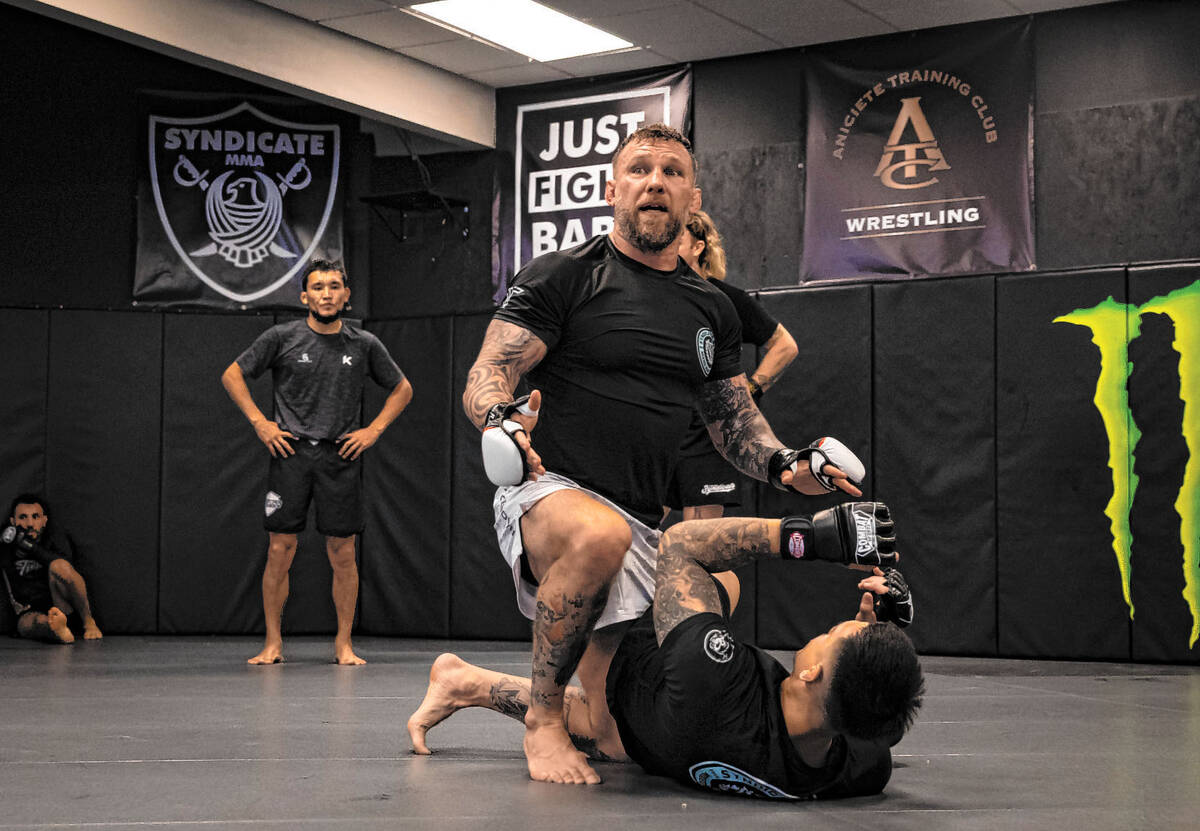 John Wood, owner and coach at Syndicate Mixed Martial Arts, left, demonstrates during a trainin ...