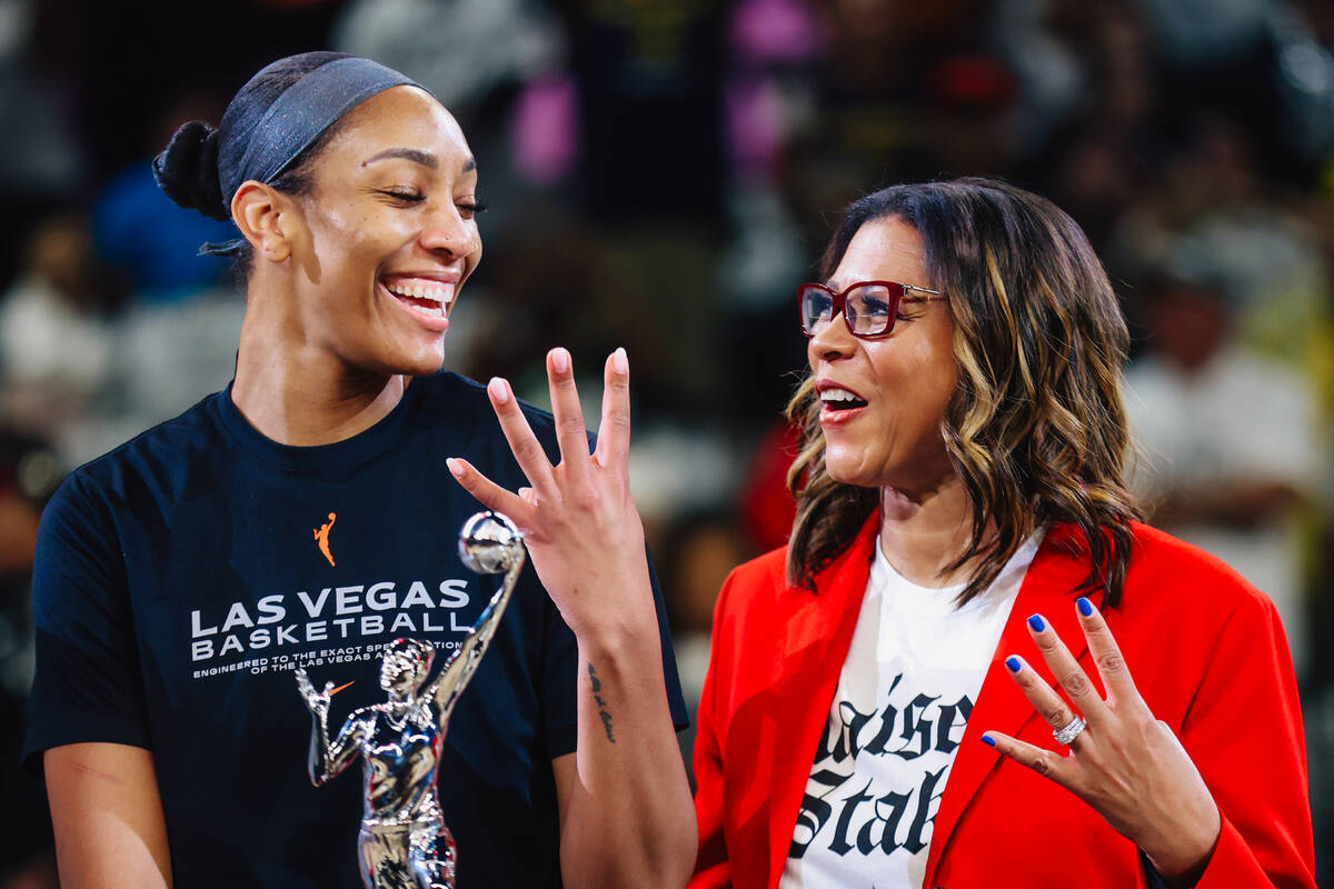 Aces center A'ja Wilson, left, poses with her MVP trophy and Aces president Nikki Fargas b ...