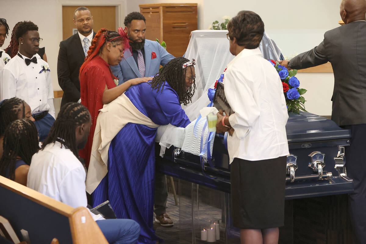 Mishon Thomas, mother of 12-year-old Jovonn “JoJo” Magee-Thomas, is comforted by his other ...