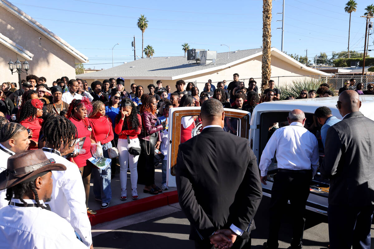 Mourners look on as the casket of 12-year-old Jovonn “JoJo” Magee-Thomas is loaded at Abund ...