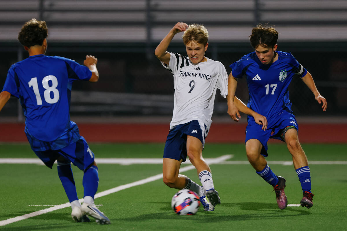 Shadow Ridge midfielder Jack Bailey (9) tries to keep the ball away from Green Valley midfielde ...