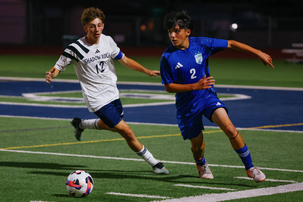 Green Valley halfback Christopher Rueda (2) dribbles around Shadow Ridge striker Gavin Meng (12 ...
