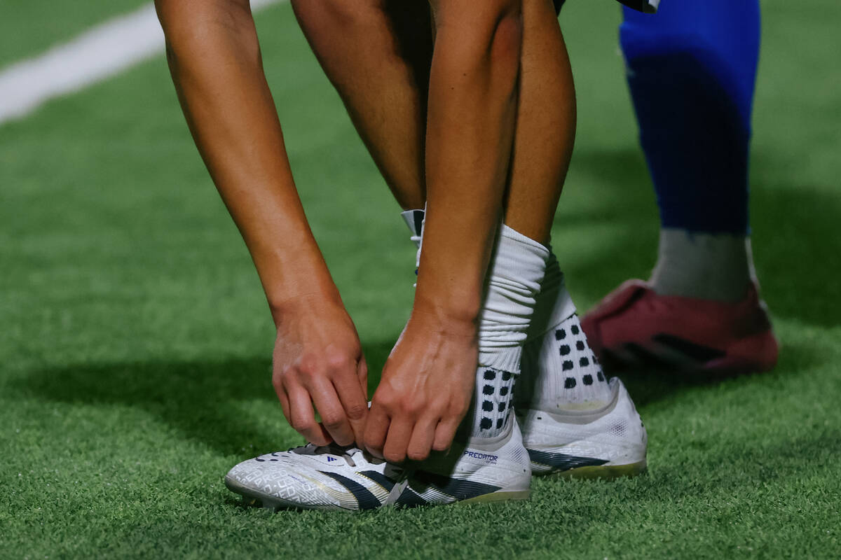 Shadow Ridge midfielder Elliot Iniguez (2) ties his shoe before a throw-in during a first round ...