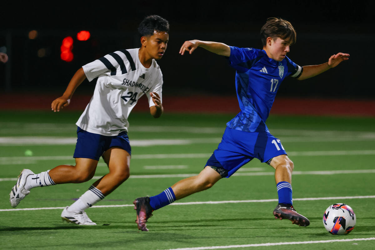 Green Valley midfielder Liam Gilbert (17) dribbles past Shadow Ridge's Noah Calvo (24) in ...