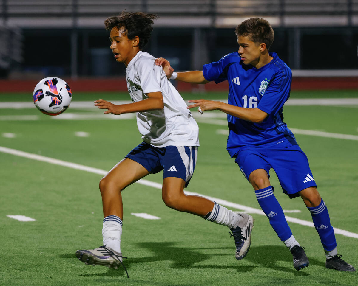 Shadow Ridge's Xavien Hood (8) controls a high ball with pressure from Green Valley midfie ...