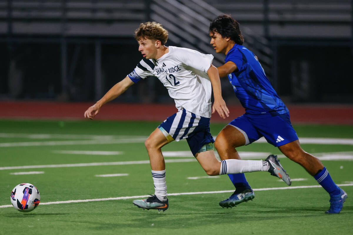 Shadow Ridge striker Gavin Meng (12) sprints to beat Green Valley defender Adrian Garcia (14) t ...