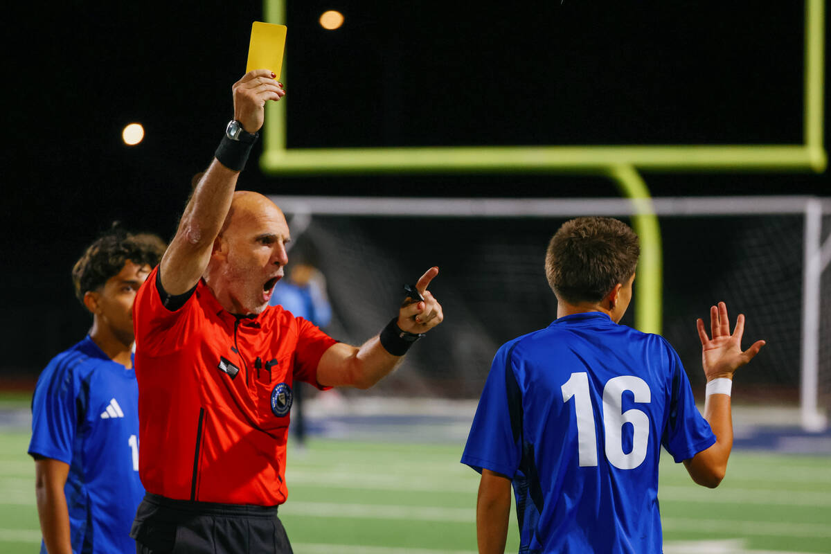 The referee hands out a yellow card to Green Valley midfielder Mateo Gilbert (16) during a firs ...