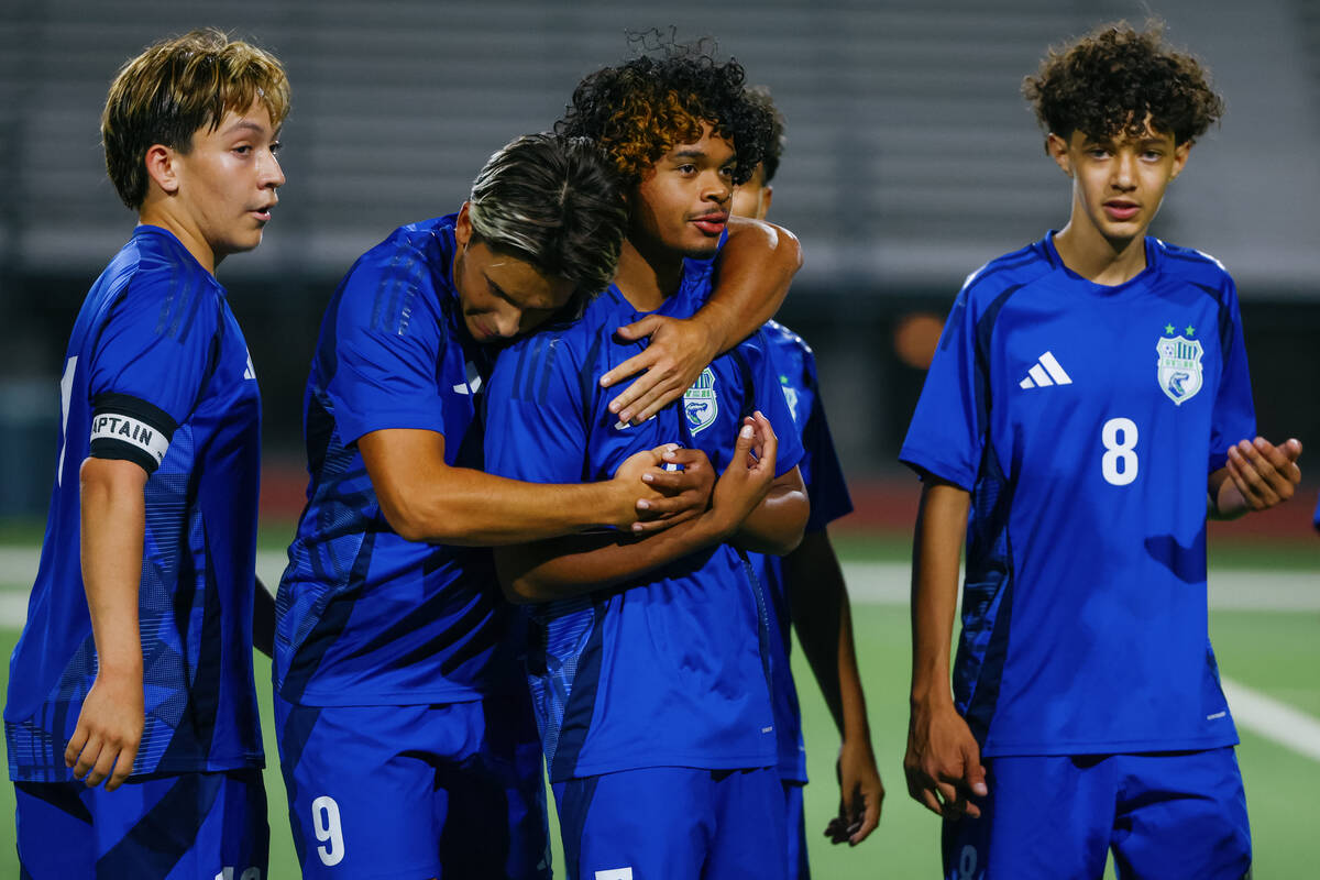 Green Valley forward Amilcar Cipili (9) and Green Valley defender Dorean Burns (7), center, emb ...