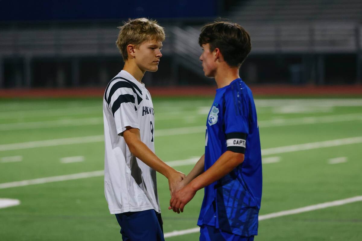 Green Valley midfielder Liam Gilbert (17) and Shadow Ridge midfielder Jack Bailey (9) clap hand ...
