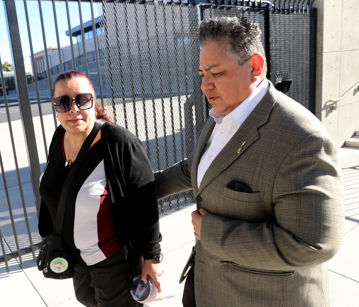 Jeanne Llera, the mother of Jorge Gomez, left, and an unidentified person leave Lloyd George U. ...