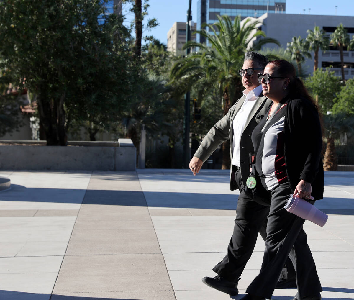 Jeanne Llera, the mother of Jorge Gomez, right, and an unidentified person arrive at Lloyd Geor ...