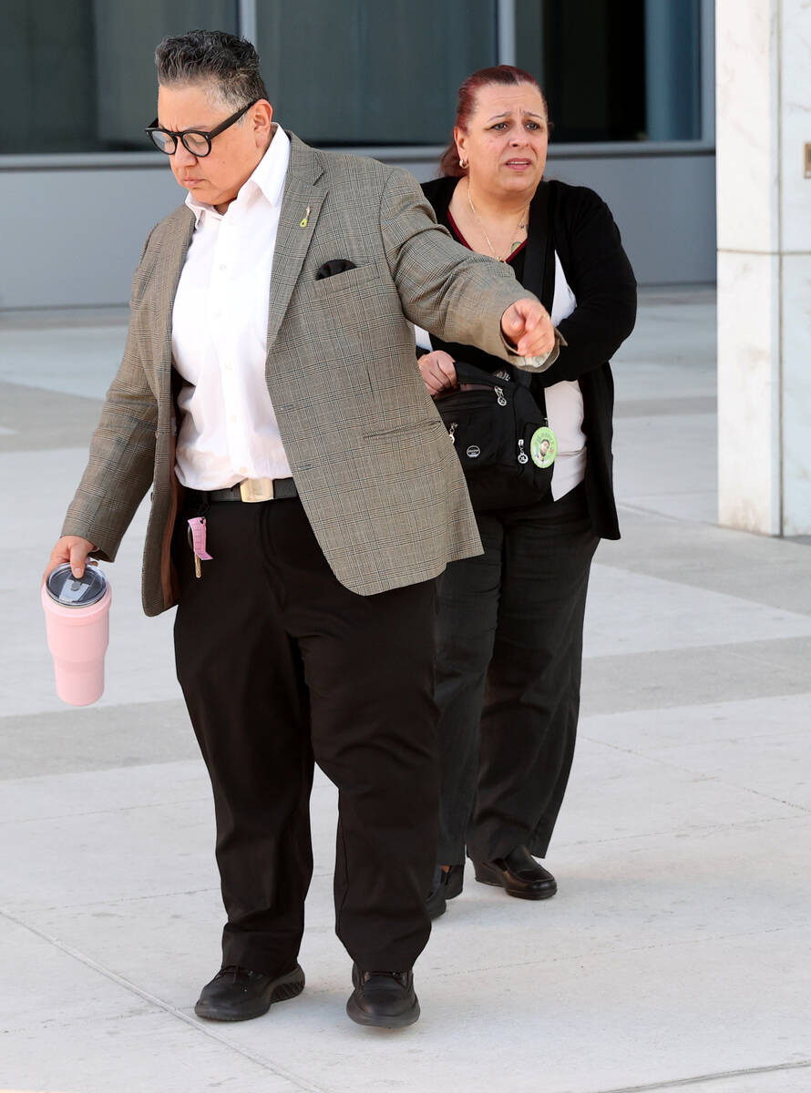 Jeanne Llera, the mother of Jorge Gomez, right, and an unidentified person walk out of Lloyd Ge ...