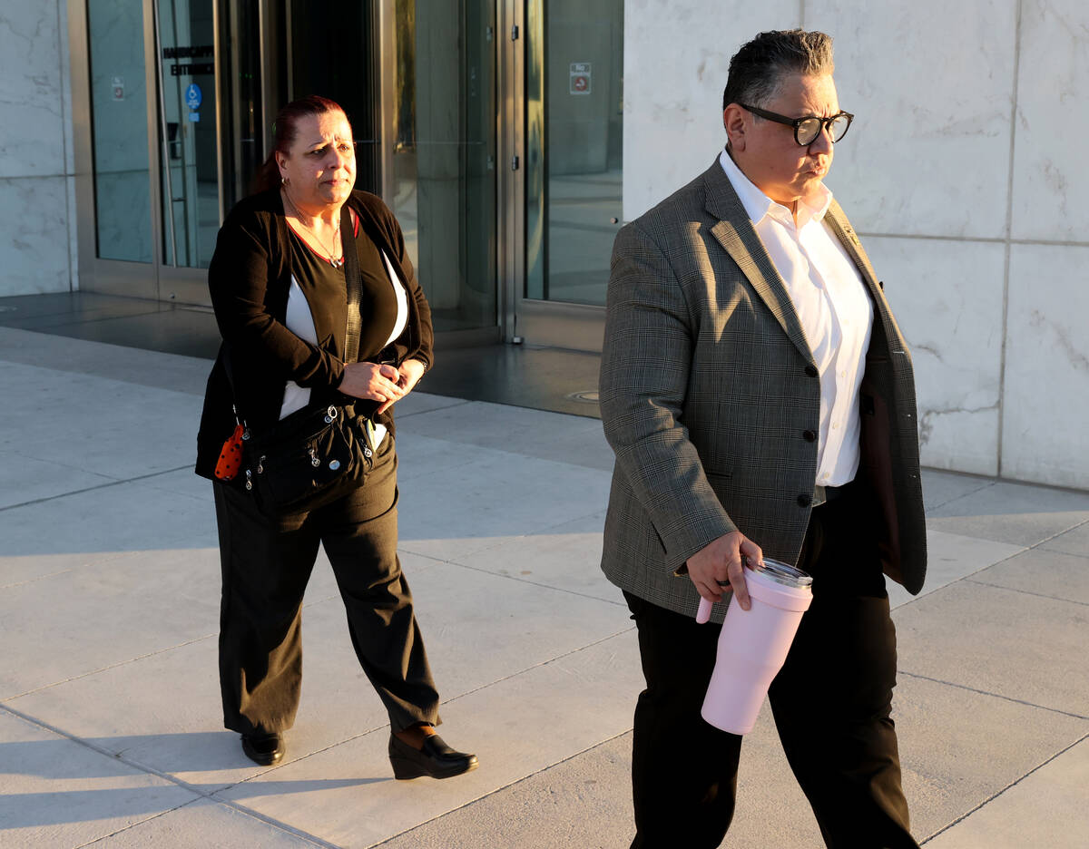 Jeanne Llera, the mother of Jorge Gomez, left, and an unidentified person walk out of Lloyd Geo ...