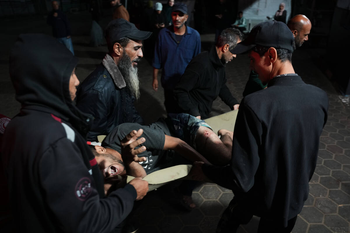 Palestinians injured in an Israeli army strike are brought to Al-Aqsa Hospital in Deir al-Balah ...