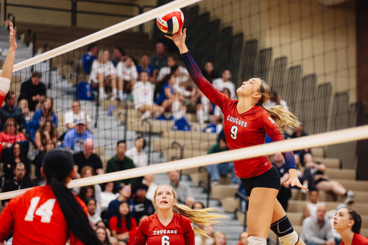 Coronado middle blocker Rachel Purser tips the ball over the net during a 5A girls volleyball S ...