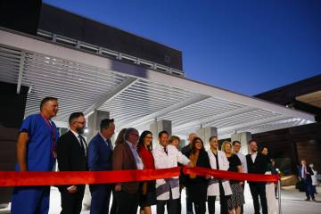 James Mah, dean of the UNLV School of Dental Medicine, center, cuts the ribbon on the school’ ...
