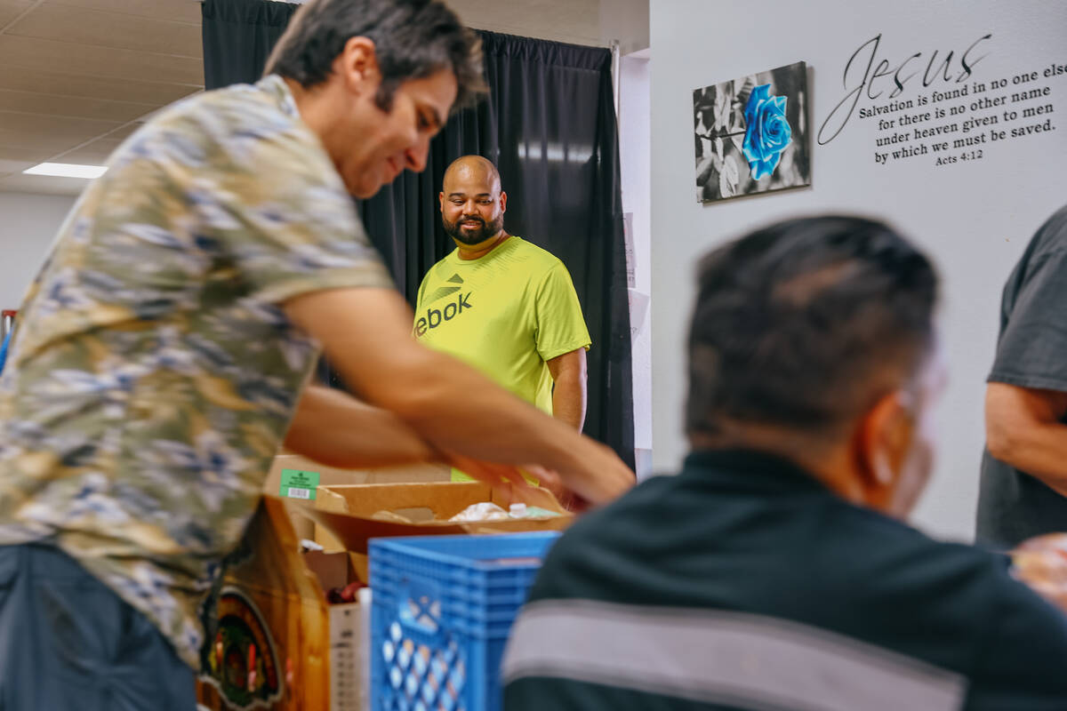 Randy Alberto Gonzalez stands in line as volunteers assemble and distribute boxes of food at Ci ...