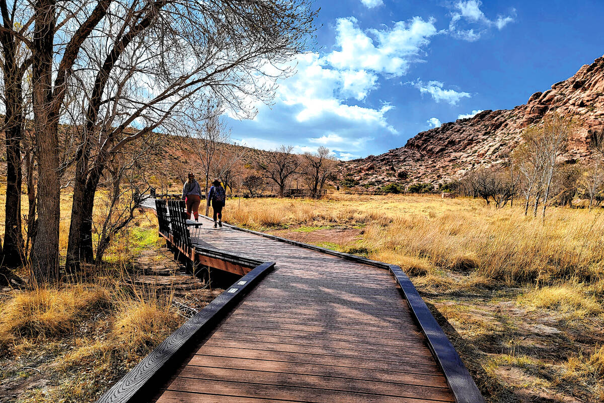 Two visitors enjoy a stroll along the boardwalk at Red Springs in the Calico Basin area of Red ...