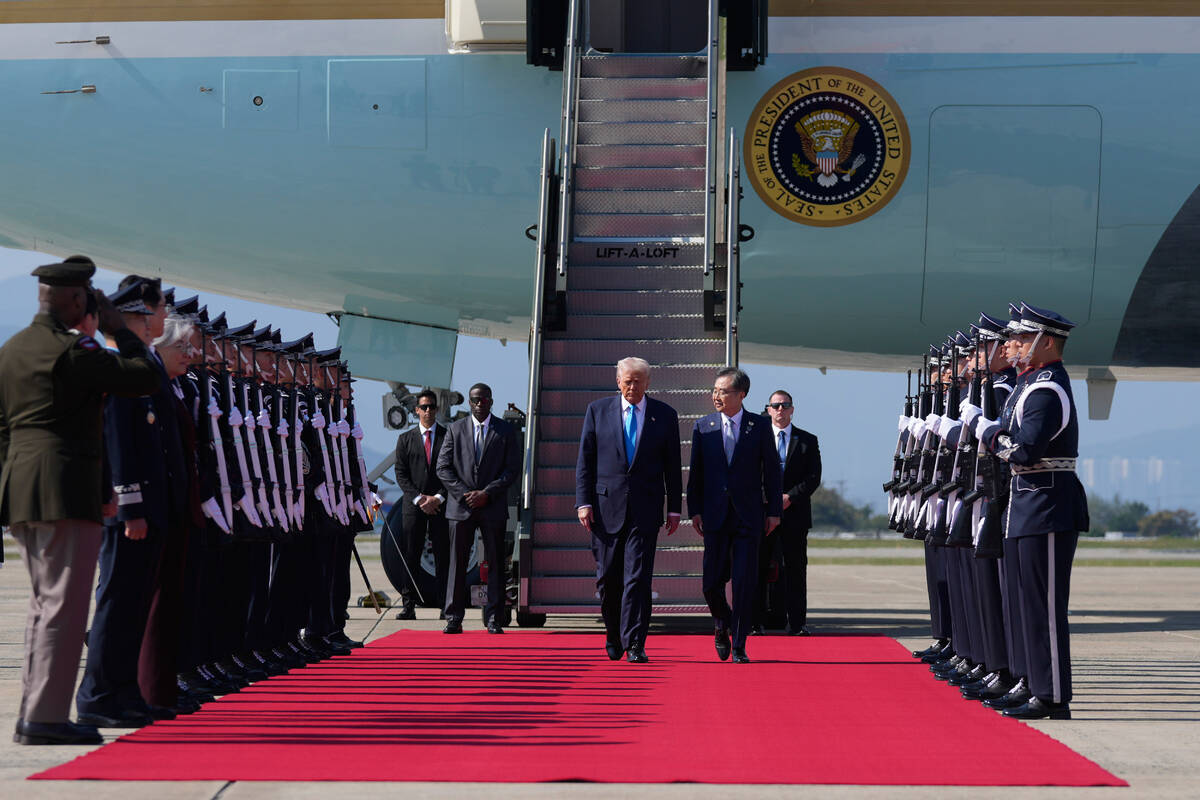 President Donald Trump, center, steps off Air Force One at Gimhae International Airport in Busa ...