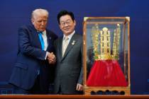 President Donald Trump shakes hands with South Korean President Lee Jae Myung as he receives a ...