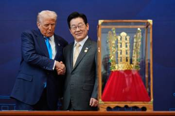 President Donald Trump shakes hands with South Korean President Lee Jae Myung as he receives a ...