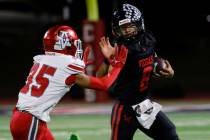 Las Vegas High's quarterback Tanner Vibabul (8) avoids a tackle from Arbo View's defe ...