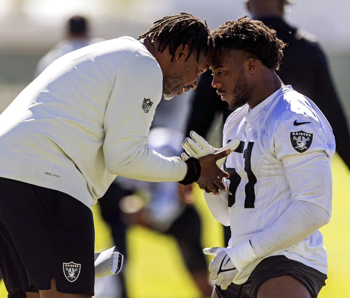 Raiders defensive coordinator Patrick Graham interacts with defensive end Malcolm Koonce (51) d ...