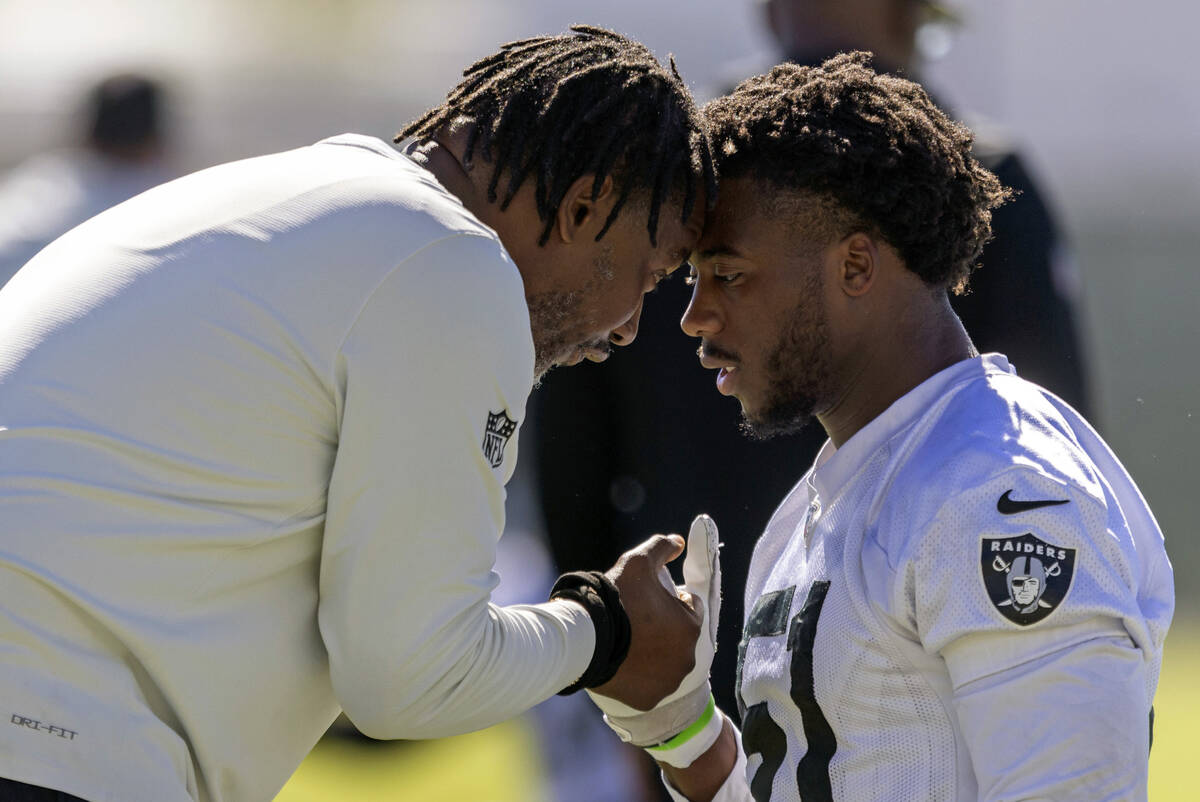 Raiders defensive coordinator Patrick Graham interacts with defensive end Malcolm Koonce (51) d ...