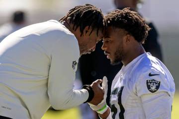 Raiders defensive coordinator Patrick Graham interacts with defensive end Malcolm Koonce (51) d ...