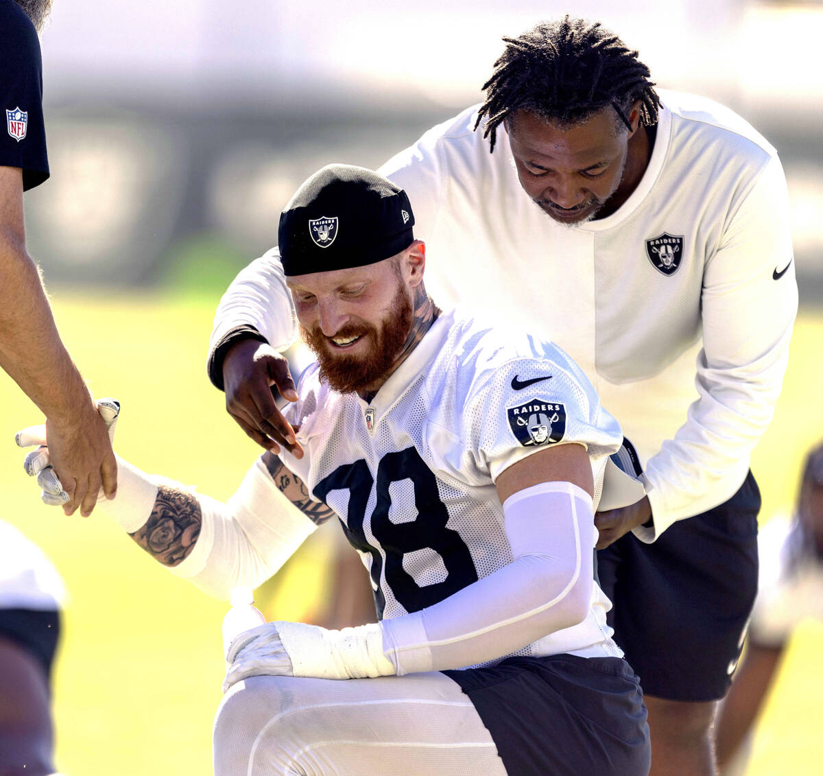 Raiders defensive coordinator Patrick Graham interacts with defensive end Maxx Crosby (98) duri ...